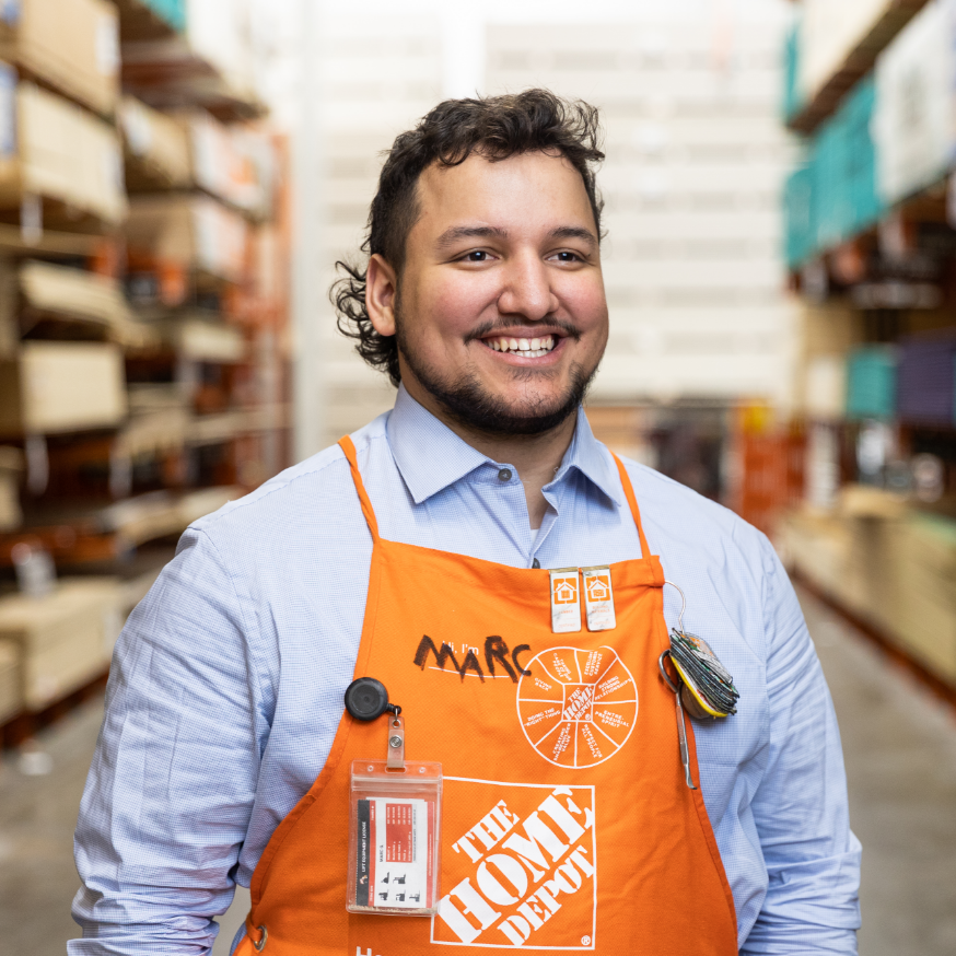 Man wearing orange Home Depot apron smiling