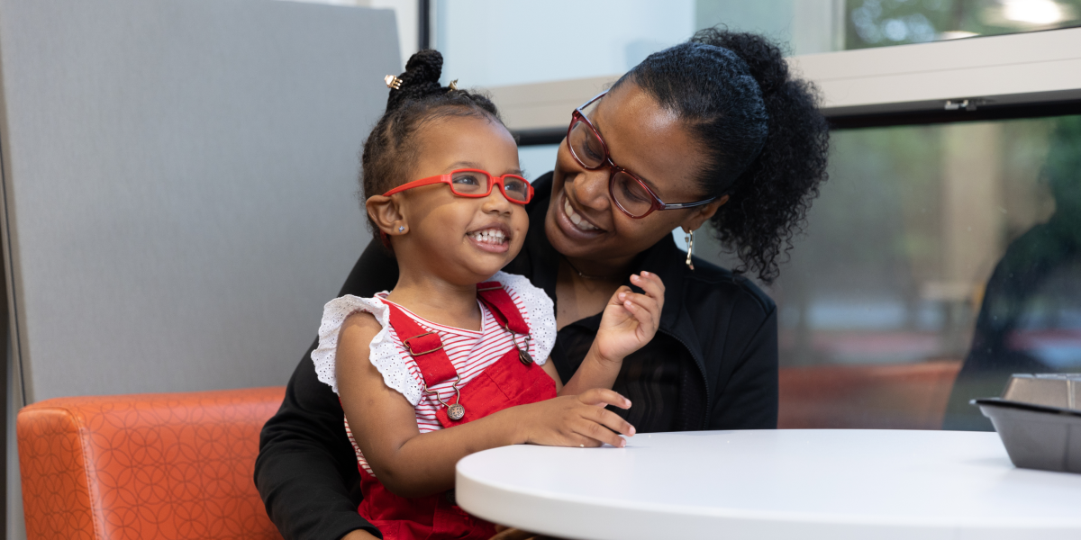 A woman and child smiling together
